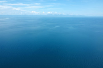 Obraz premium drone shot of the blue seascape with little clouds
