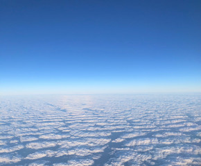blue sky with clouds; with the horizon to be seen