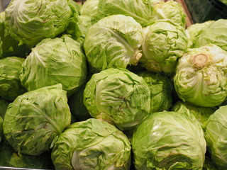 Fototapeta premium fresh cabbage at the supermarket kiosk. Fresh cabbage on display in the grocery store. cabbage on the shelves in the usual market