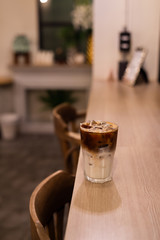 iced coffee put on wooden table in mini cafe