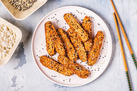 Fried tempeh  with sesame seeds.