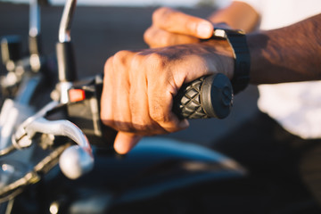 Unrecognizable motorcyclist using smart watch