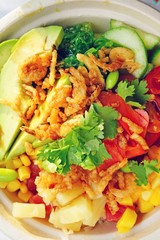 A poke bowl with ahi tuna, avocado, edamame, and seaweed salad