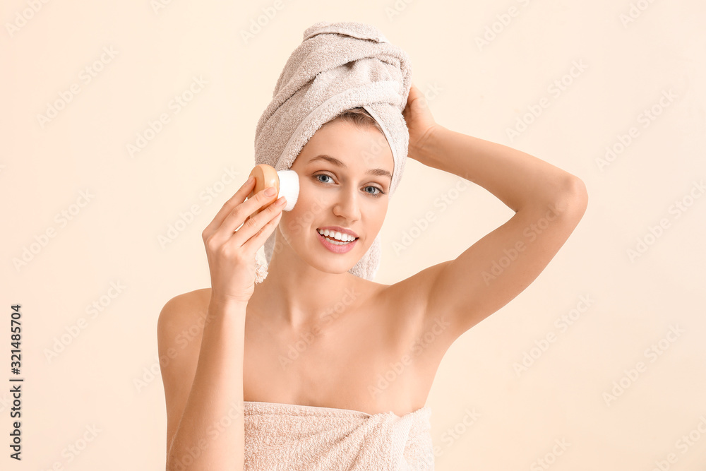 Canvas Prints Beautiful young woman with massage brush on light background