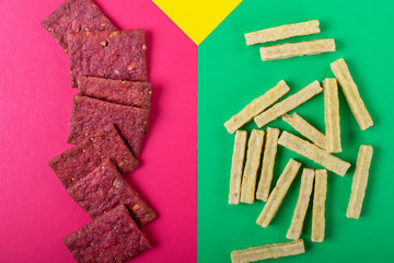 Crispbreads assortment for healthy nutrition on the multicolored background, Flat lay with snacks
