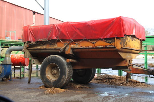 Agricultural covered red trailer engine