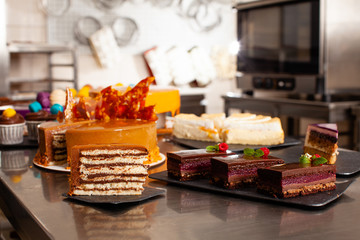 Pieces of delicious cakes on a professional confectionery kitchen