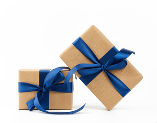 rectangle box wrapped in brown kraft paper and tied with a silk blue ribbon