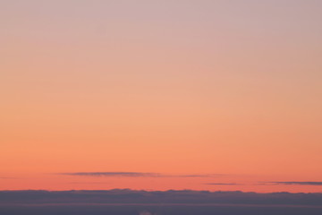 A beautifully backlit colorful sunset sky with the colors of sunrise and sunset.