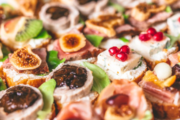 Tasty canapes and appetizers catering service buffet meal concept.