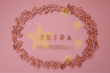 China word of wooden letters with thermometer on backround with china flag: pandemic virus infection from Wuhan, China, novel Coronavirus outbreak.