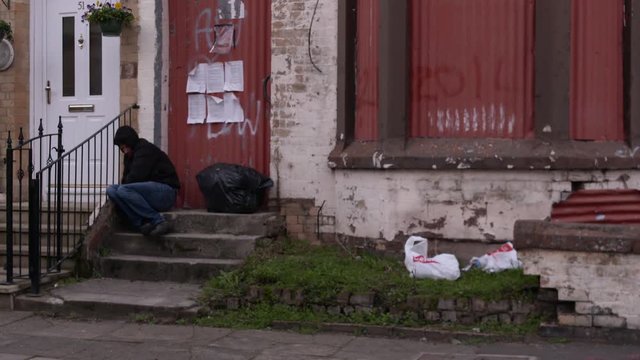 still shot of man sitting on stairs asleep