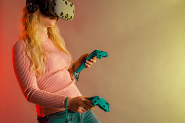 Woman with virtual reality headset and joystick playing VR games