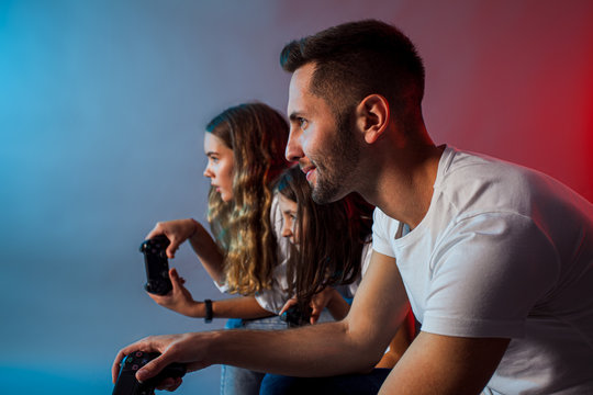 Happy Family Playing Video Games Together At Club