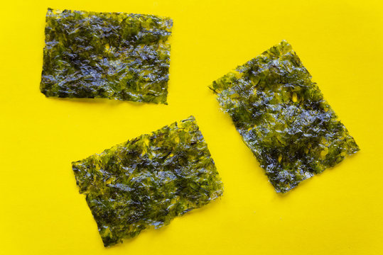 traditional japanese dried nori seaweed isolated on yellow 
