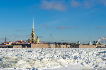 Russia. Saint Petersburg. Peter and Paul Fortress on a frosty winter, sunny day. Blocks of ice on the Neva River.