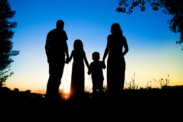 Fototapeta premium silhouette of a happy family with children