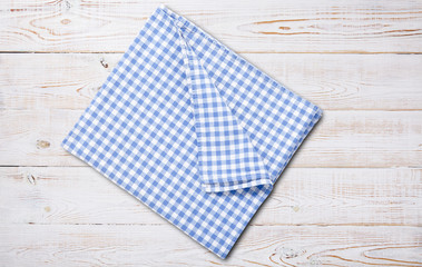Obraz premium Napkin. Kitchen towel or table cloth on white wooden scene. Mock up for design. Top view.
