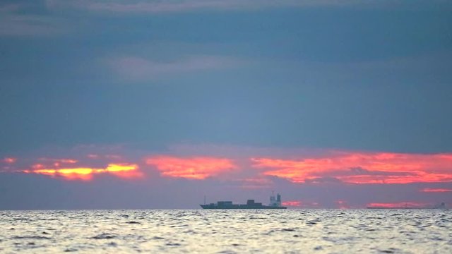 sunset on the sea and focus to chago ship is parking