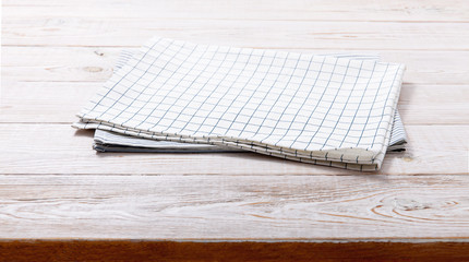 Napkin. Kitchen towel or table cloth on white wooden scene. Mock up for design. Top view.