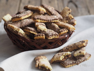 Homemade sandwich puff pastry chocolate cookies in a wicker natural plate from the vine. Wooden ancient table. View from above.