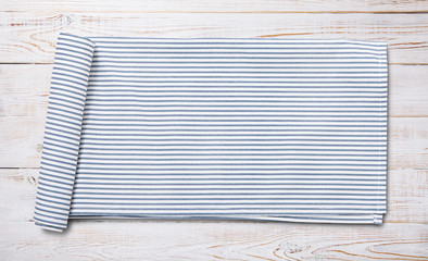 Napkin. Kitchen towel or table cloth on white wooden scene. Mock up for design. Top view.