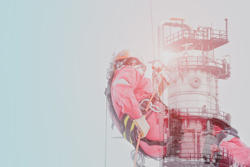 Double exposure abseiling worker on high wear dresses with oil refinery plant and safety man with harness concept. - obrazy, fototapety, plakaty