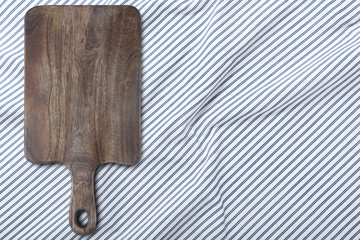 Cutting board and napkin on white wooden table. Empty tray mock up for design. Top view.