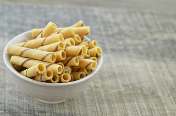Vanilla waffle roll sticks in ceramic bowl