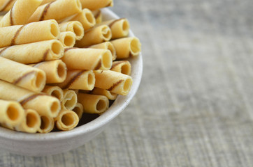 Vanilla waffle roll sticks in ceramic bowl