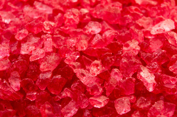 Red crystals minerals bath salts close-up. Macro photo