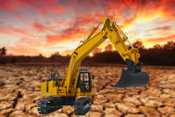 Excavators loader on the dry ground background,With light sunrise