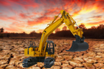 Excavators loader on the dry ground background,With light sunrise