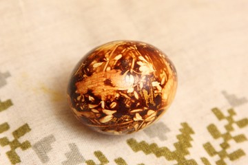 Yellow and brown Easter eggs painted in natural onion bark. Easter egg in old traditional latvian style