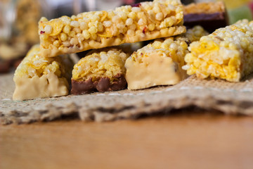 Granola Bars and mixed nuts. Honey bars with peanuts, chocolate, dried fruit, sesame and sunflower seeds