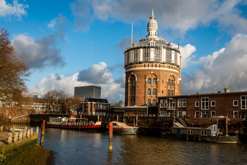 Fototapeta premium Beautiful cityscape of an old water tower in Rotterdam by the river 