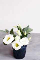 White flowers in classic blue glass. Lisianthus. Eustoma