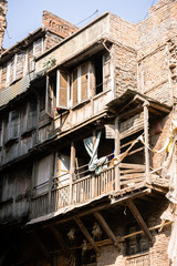 Fototapeta na wymiar Worn facades in the streets of Kathmandu during a sunny day, Nepal