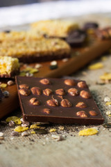 Granola Bars and mixed nuts. Honey bars with peanuts, chocolate, dried fruit, sesame and sunflower seeds