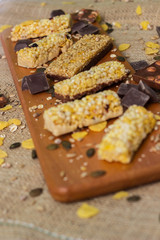 Granola Bars and mixed nuts. Honey bars with peanuts, chocolate, dried fruit, sesame and sunflower seeds