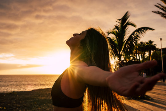 Closeup portrait of active healthy beautiful woman enjoying the sunset and the sport - people having relax time outdoor after activity exercises class or session - breathe and happiness