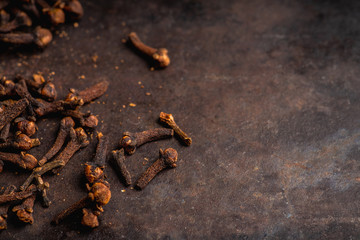 Dry cloves spices on the dark rustic background. Selective focus. shallow depth of field.