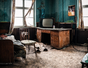 vieille télé et différentes ordures dans une pièce abandonnée