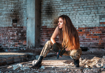 portrait of girl in military style with gun