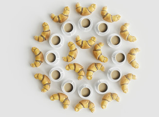 Croissants and coffee cups arranged in a circle - concept for a sweet breakfast - 3D rendering