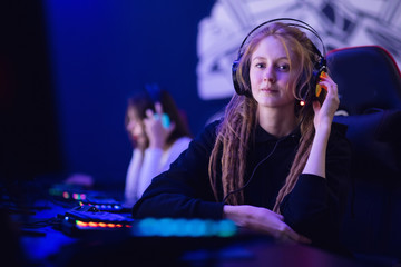 Streamer beautiful girl professional gamer winnerplaying online games computer with headphones