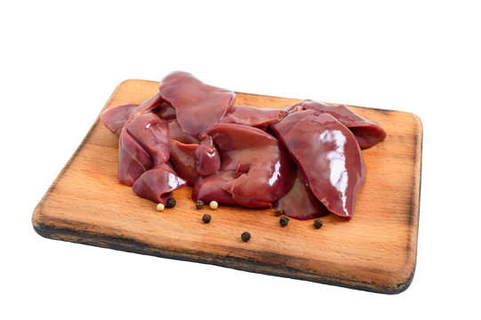 Raw chicken liver on a cutting board isolated on a white background. Offal. Ready to cook. Dishes from the liver.