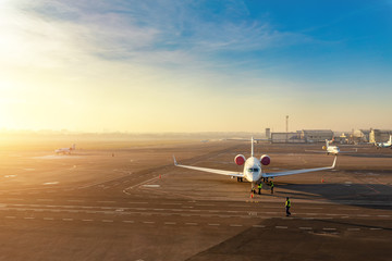 Colorful scenic dramatic morning sunset at airport asphalt taxiway and parking with different...