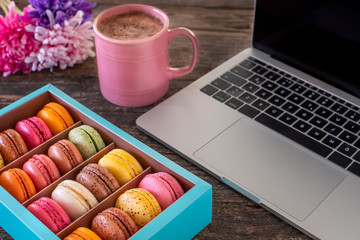 Colorful macarons in the gift box on the table