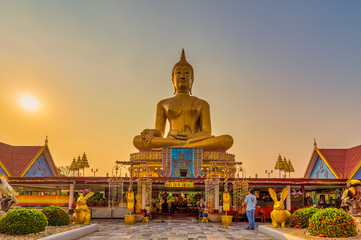 Thong, Tha Chang District, Sing Buri, Thailand, Febuary 1, 2020 : Wat Pikul Thong Phra Aram Luang, A beautiful setting with a large golden Buddha. The avenue leading to the temple is quite majestic.